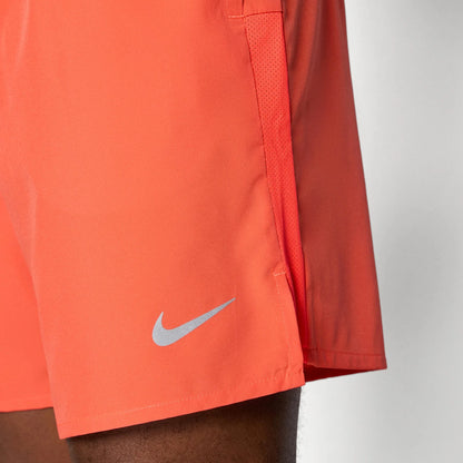 Orange athletic shorts with Nike logo on a neutral background