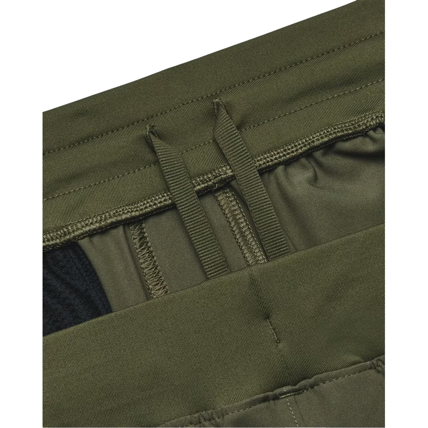 Close-up of green tactical pants with a pocket and strap detail.