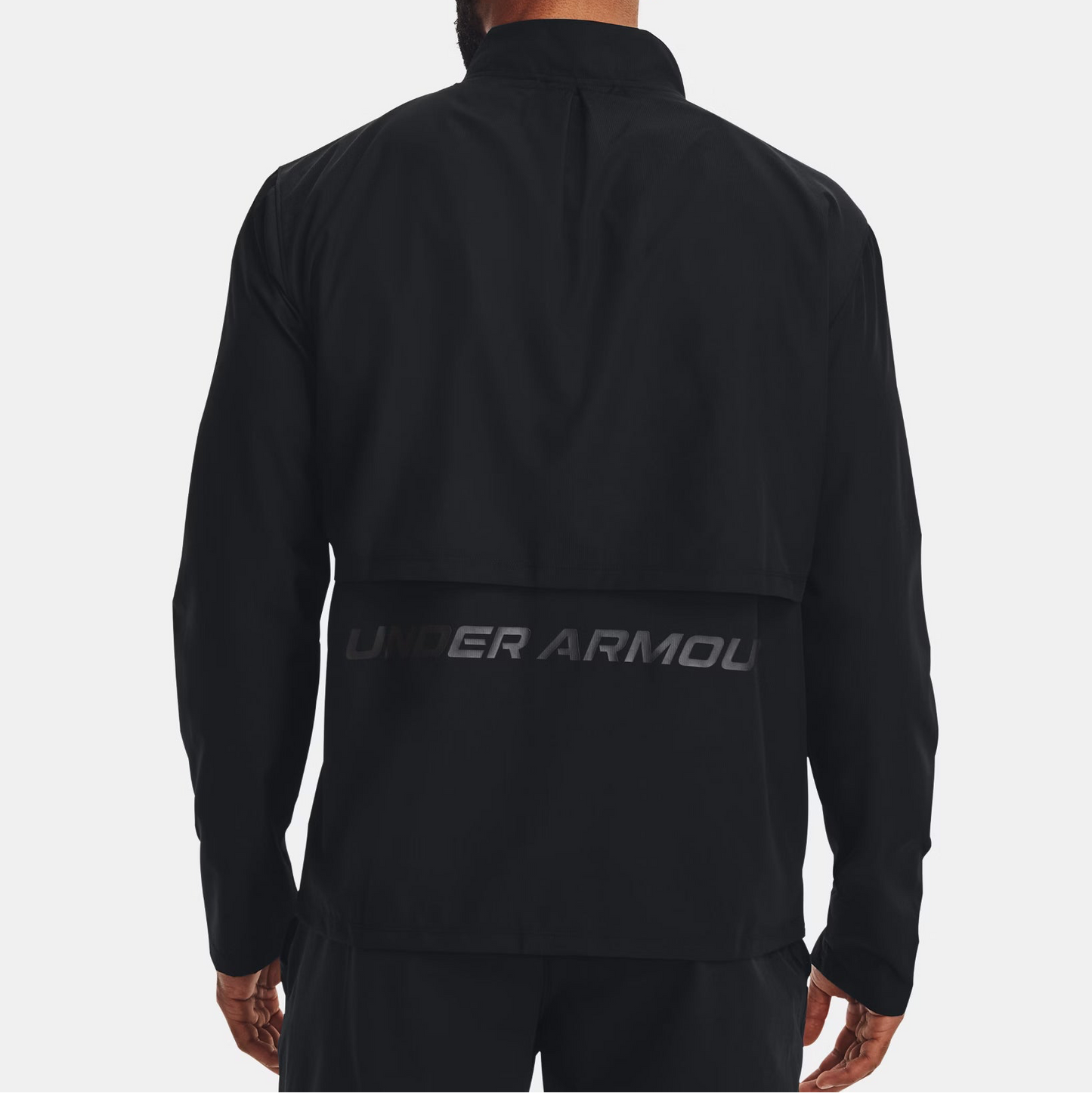 Person wearing a black Under Armour jacket on a white background