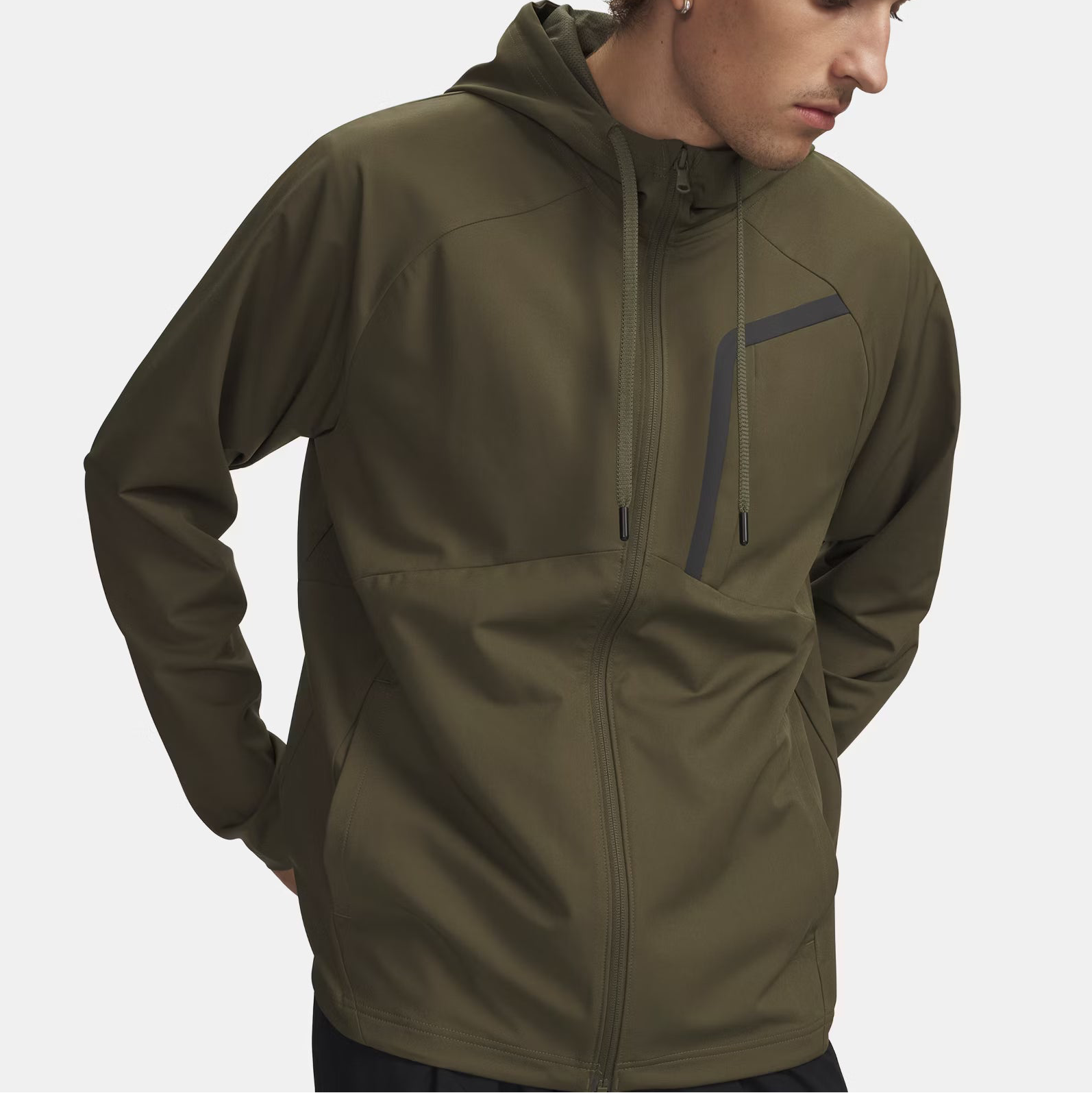 Man wearing a green jacket on a light gray background
