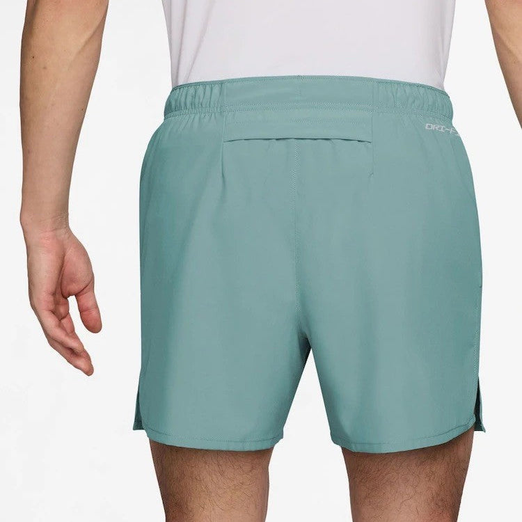 Teal shorts worn by a person on a white background